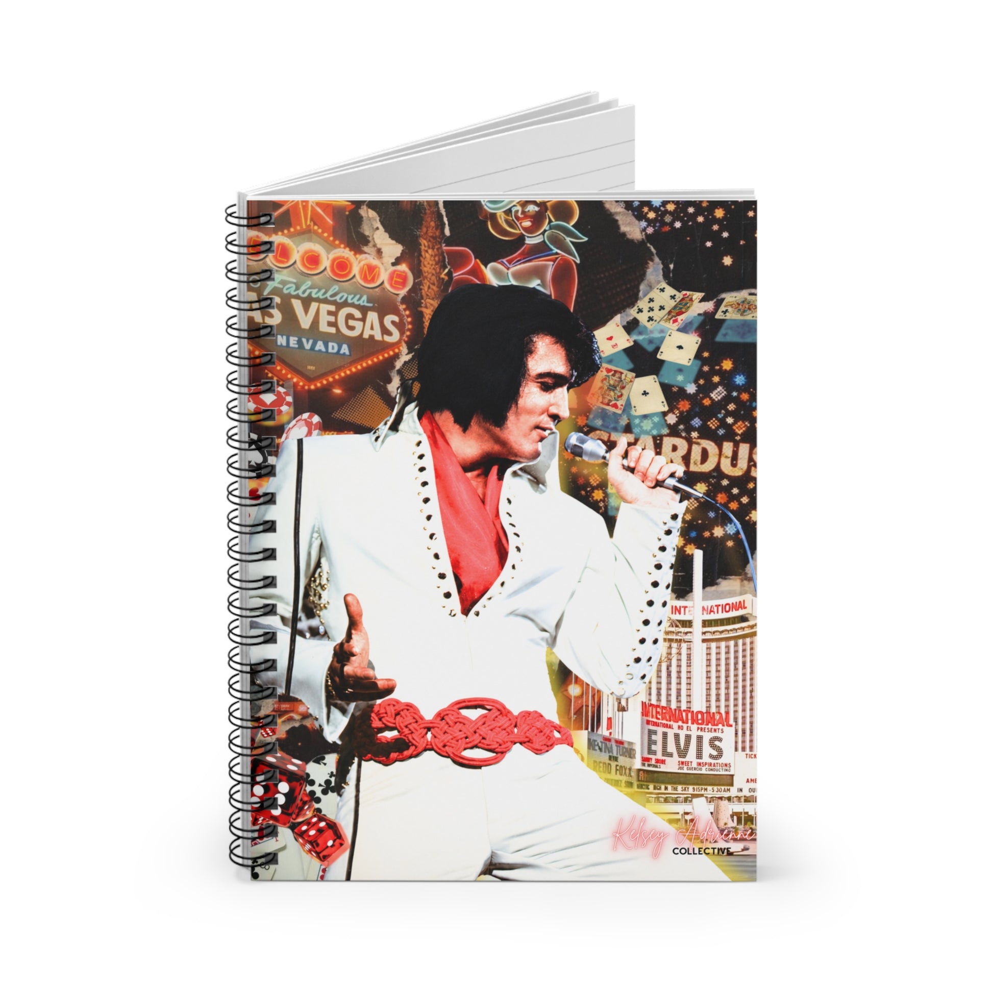 A spiral-bound notebook featuring a colorful collage-style cover print of Elvis Presley in a white suit with a red vest, set against a Las Vegas-themed background with casino signs and buildings.